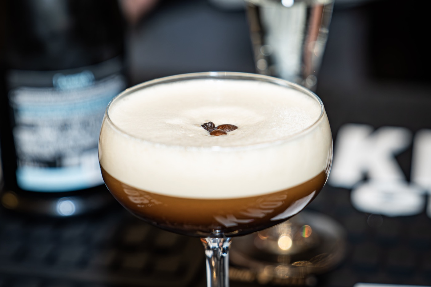 Espresso martini at Little Alley Steak Alpharetta — served coupe-up with a thick crema head and three coffee beans